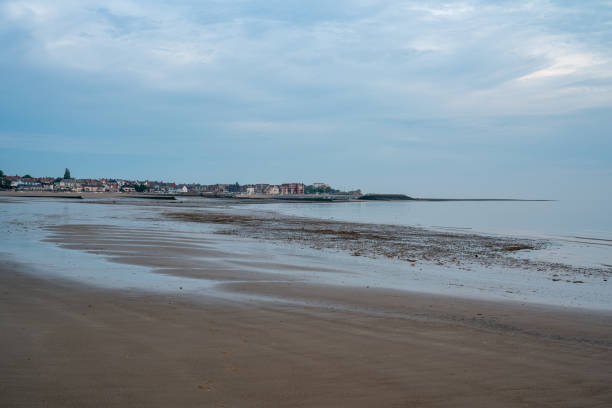 Empty beach and seafront at Rhos-on-Sea, Wales UK at low tide.