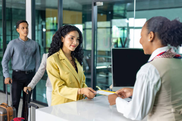 istock Passenger is getting boarding pass from the airline ground crew at departure gate into the airplane for flight check in before boarding into plane 2154244592