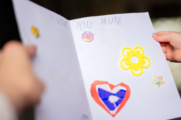 istock Child's hands holding card for Mother's day 2154245632