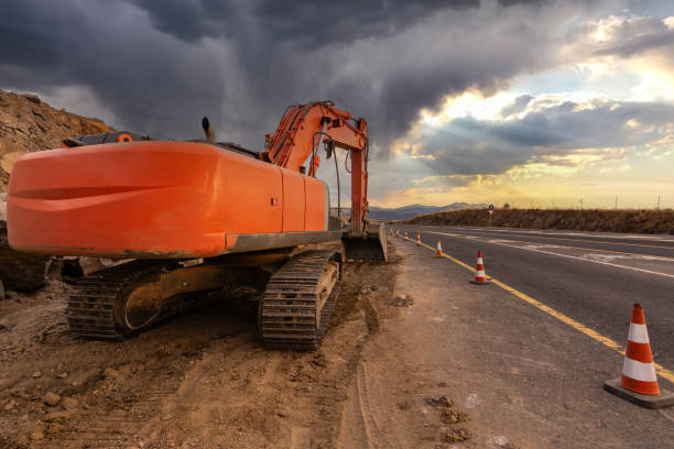 istock Excavator making earth movements for the construction of a road 2154245798