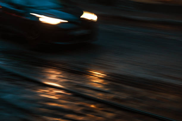 istock Car lights with highlights on a cobbled road at night 2154246403