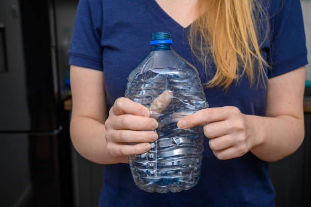 istock Used PET plastic water bottle crushed in hands 2154247042