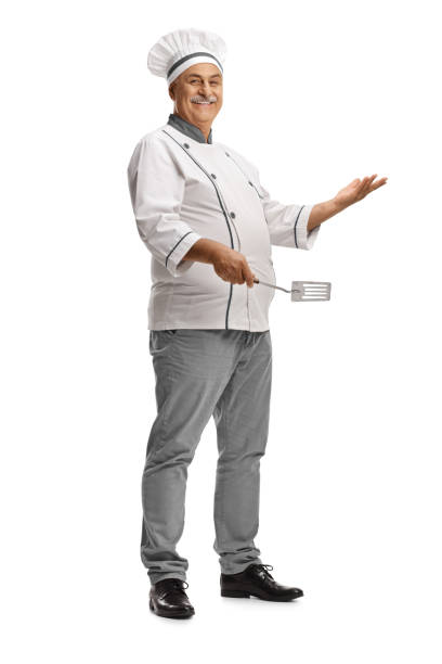 Mature male chef holding a turner utensil