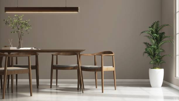 istock Modern, minimal brown wooden dining table, chairs, pendant light and tree in sunlight from window on luxury beige wall dining room 2154249050