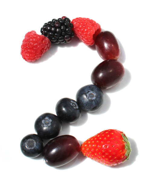 number 2 from raspberry, blackberry, strawberry with green leaf, blueberries, grape. isolated berries numbers for second birthday party