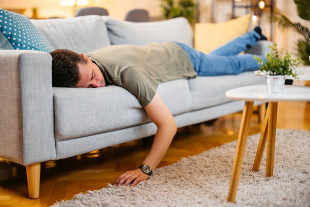 istock Young Man Sleeping On The Sofa At Home 2154250464