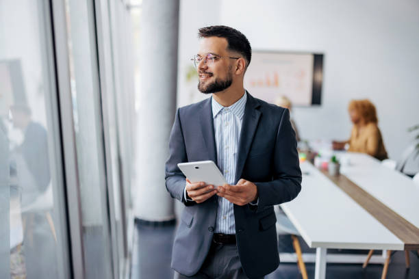 istock Confident businessman with a digital tablet 2154250642