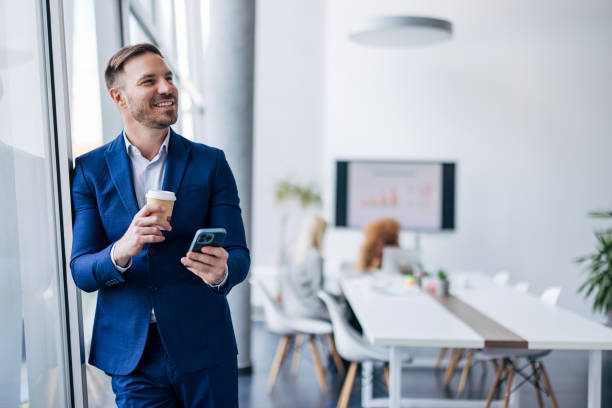 istock Business executive with mobile phone and coffee 2154250888