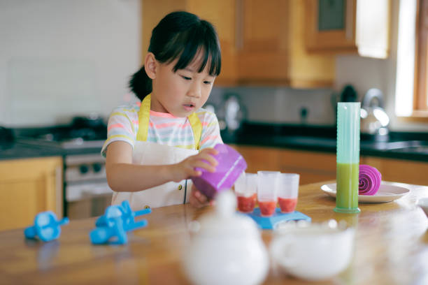 istock young girl making ice lollies at home 2154251747