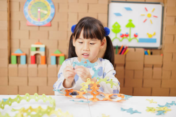 istock young girl playing Construction toys at home 2154251750