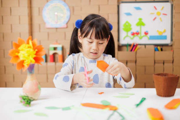 istock young girl making craft at home 2154251765