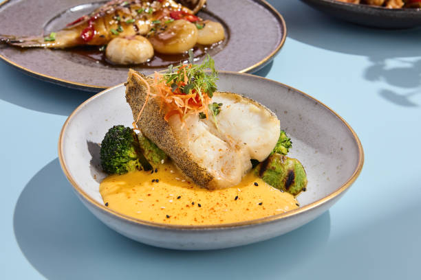 Halibut steak with pumpkin puree and broccoli, ideal for a vibrant summer menu in a high-end eatery