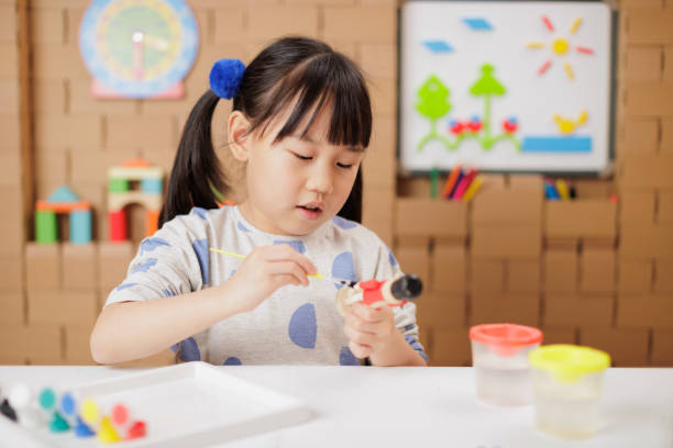istock young girl making craft at home 2154251948