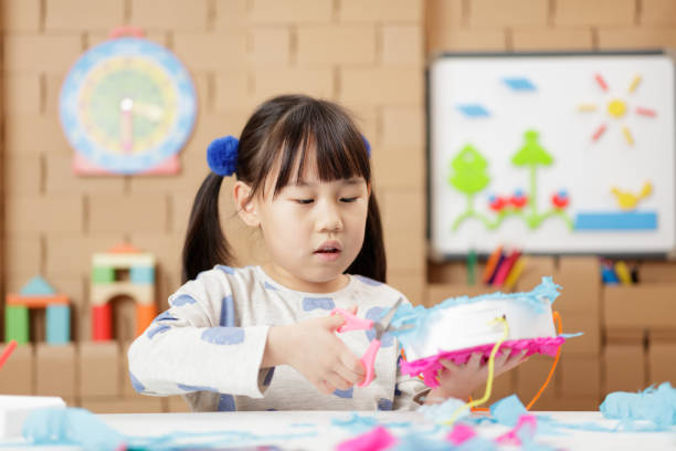 istock young girl making craft at home 2154251975