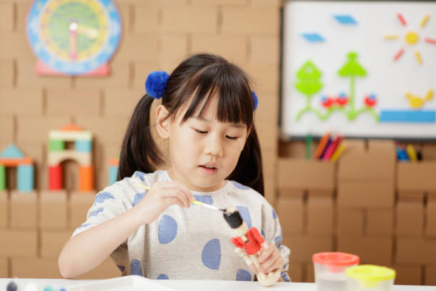 istock young girl making craft at home 2154251978