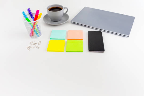 Office desk table with computer,  mobile phone, supplies, sticky notes, coffee  and coloured pens. Top view with copy space. Flat lay. Time management.