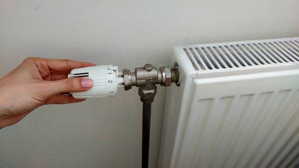 istock White radiator in the apartment 2154255836