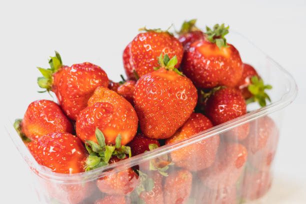istock Fresh red strawberries in a package on white background. 2154260111