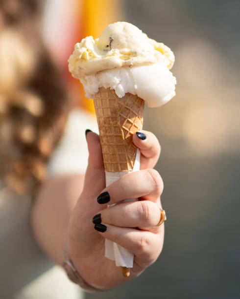 istock Cone of delicious ice cream in one hand. 2154261757