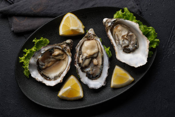 istock Fresh oysters with lemon on plate 2154261970