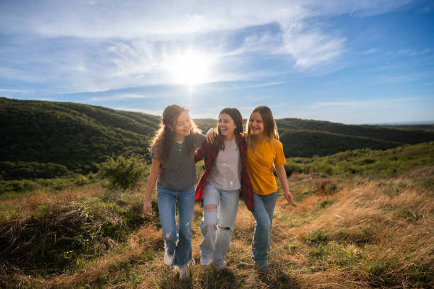 istock Three teenage friends walking on a hill 2154262026