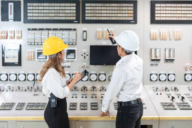 istock With precision and expertise in the industrial field, two Asian engineers oversee operations at the power plant, their laptops and blueprints in hand, ensuring efficient power generation. 2154264216
