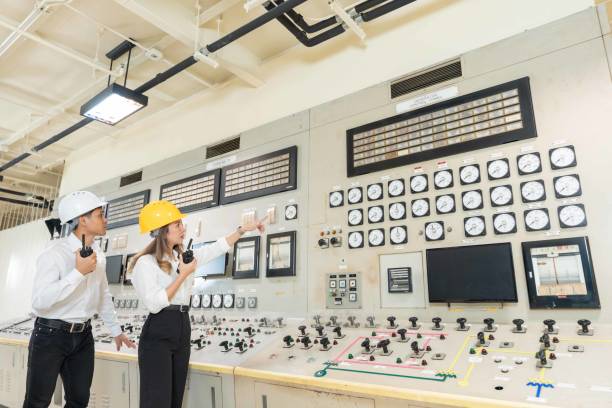 istock Two Asian male and female engineers driven by a passion for caring for the environment. Industrial work at a power plant Walk through the control panel to maximize energy efficiency. 2154264301