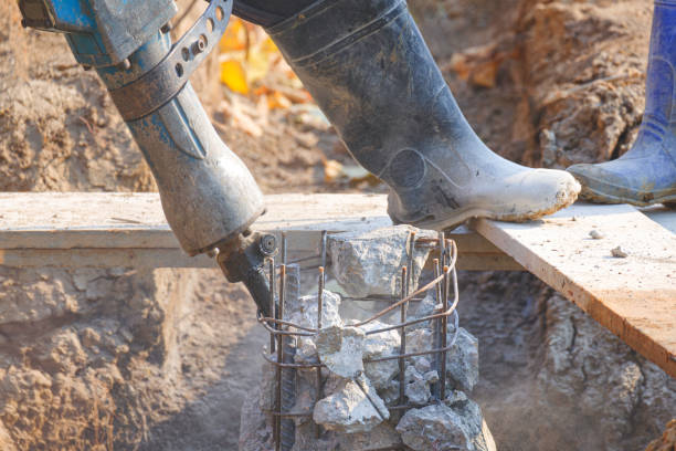 istock Cropped image of construction worker using jackhammer drilling equipment to breaking the old reinforced concrete foundation pier in construction site 2154266542