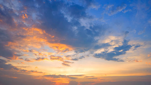 istock Dramatic sunset horizon sky with orange sunlight and dark clouds on blue idyllic dusk sky background in evening time 2154266559