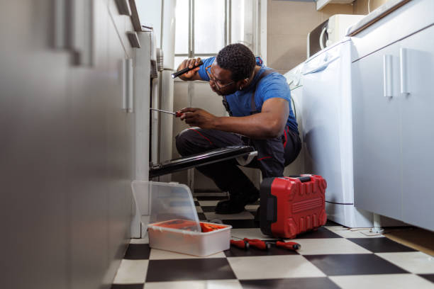 istock Young handyman repairing stove in a client's kitchen 2154268610