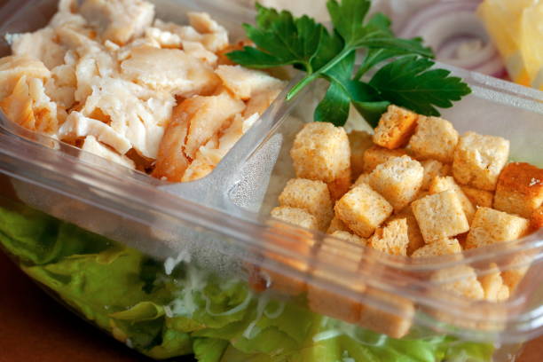 istock Caesar salad packed chicken and mayonnaise in plastic box close up 2154271345