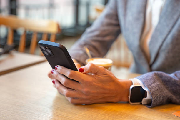istock Unrecognizable Caucasian business woman using an app on her smartphone in a cafe 2154274663