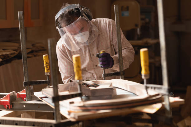 istock Portrait of carpenter using clamps for wood in carpentry workshop 2154277193