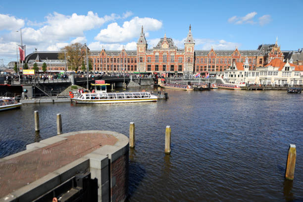 Damrak and Centraal Station in Amsterdam, Netherlands.
