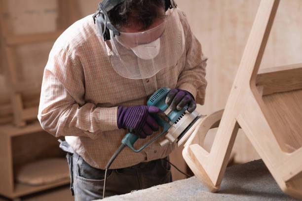 istock Carpenter operating with grinder for woodworking in a furniture workshop 2154277342