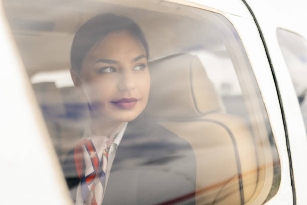 istock Stewardess sitting in an airplane, looking outside the window 2154277624