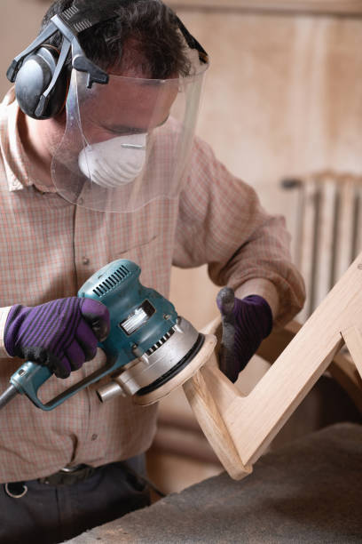 istock Carpenter operating with grinder for woodworking in a furniture workshop 2154278270