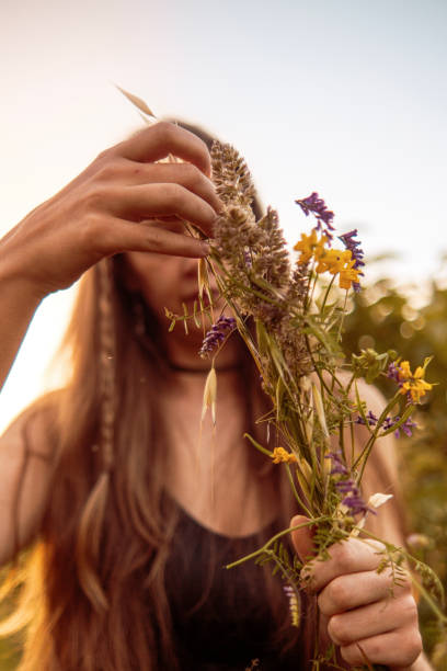 istock One beautiful young woman in the meadow making a bouquet 2154280137