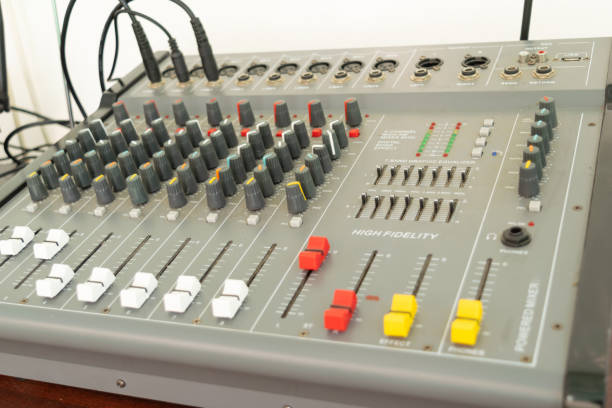 istock High fidelity audio mixing console with multiple knobs and sliders in a recording studio. Perfect for music production, sound engineering, and broadcast applications. 2154280869