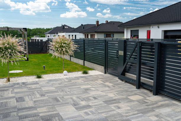 istock A modern panel fence in anthracite color, a visible sliding gate to the garage and a wicket with a letterbox. 2154281217