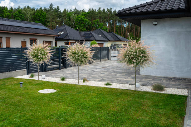 istock A modern panel fence in anthracite color, a visible sliding gate to the garage and a wicket with a letterbox. 2154281248