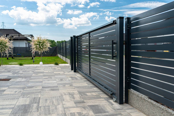 istock A modern panel fence in anthracite color, visible sliding gate to the garage and a slab driveway. 2154281271