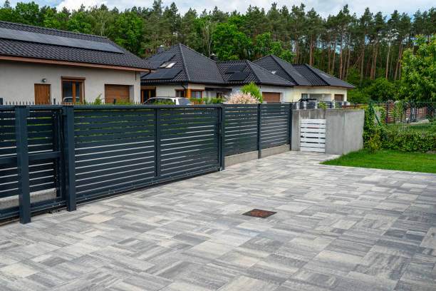 istock A modern panel fence in anthracite color, visible sliding gate to the garage and a garbage place in the corner. 2154281443
