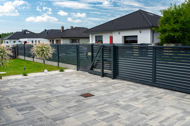 istock A modern panel fence in anthracite color, a visible sliding gate to the garage and a wicket with a letterbox. 2154281454