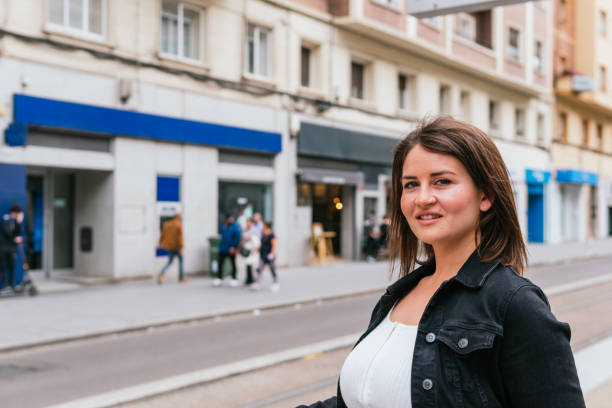 istock Smiling traveler looks at camera while waiting for the tram 2154282479