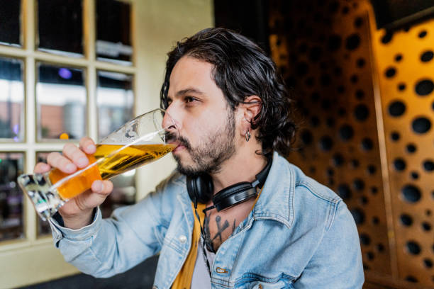istock Mid adult man drinking beer at the pub 2154283486