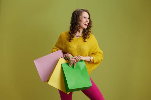 istock smiling trendy female isolated on green background 2154284033