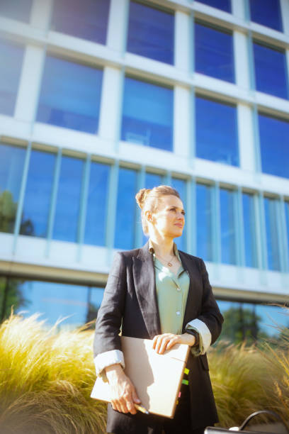 istock pensive modern female employee near office building 2154284052