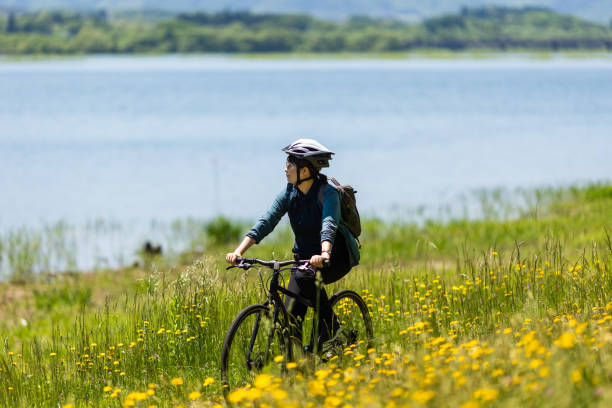 istock Woman riding bicycle in countryside nature 2154284544