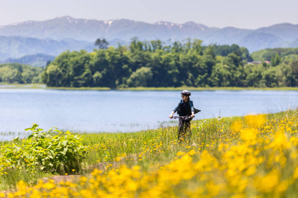 istock Woman riding bicycle in countryside nature 2154284561